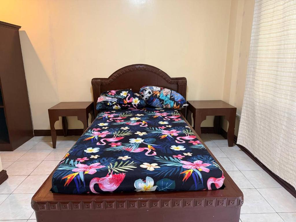 Made-up double bed in a quiet guest room at Pecan Pension House, Iloilo