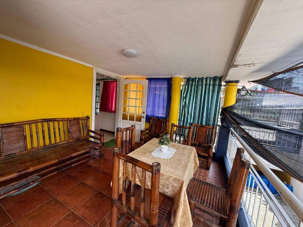 Covered balcony seating area of the on-site café at Pecan Pension House near Iloilo International Airport