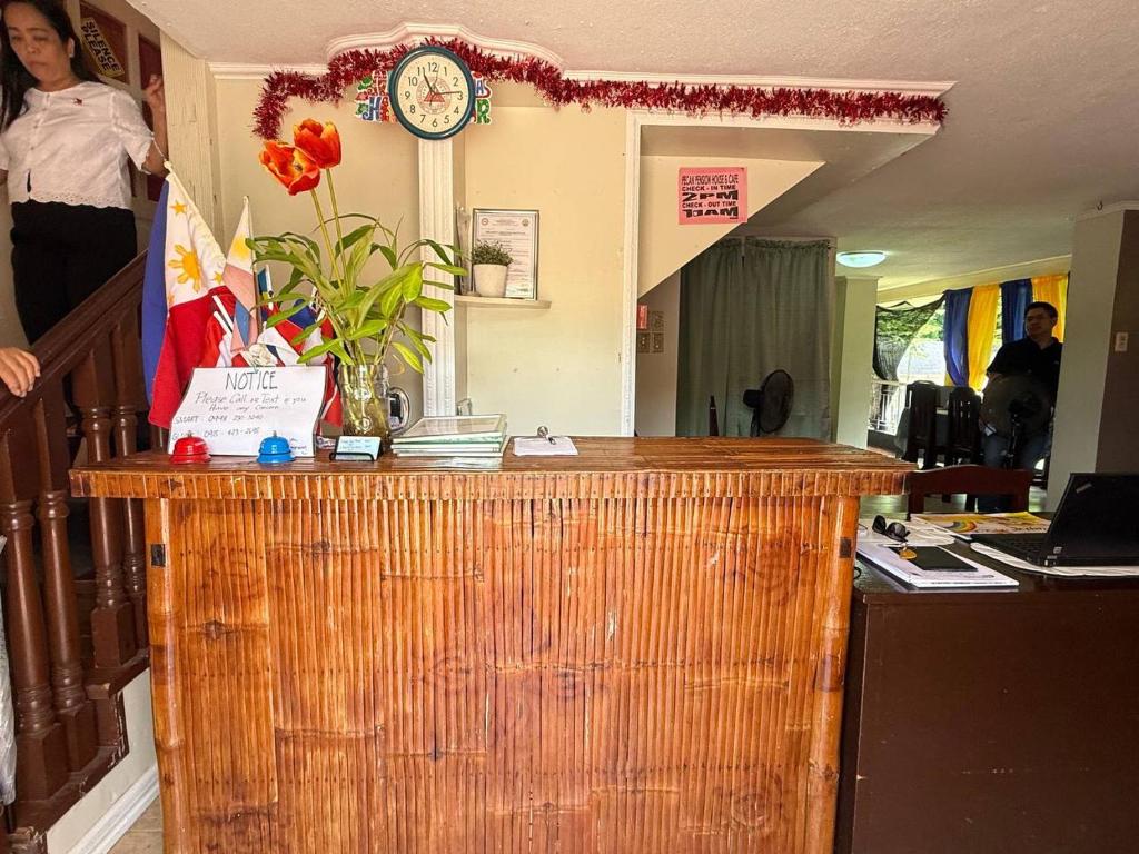 Front desk reception where staff welcome late-night arrivals at Pecan Pension House